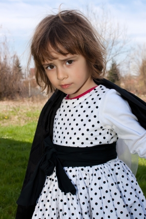 Little girl in white dress and capeの写真素材