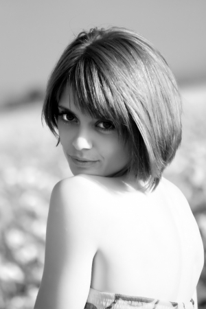 Portrait of a young beautiful woman in a field with sunflowersの写真素材