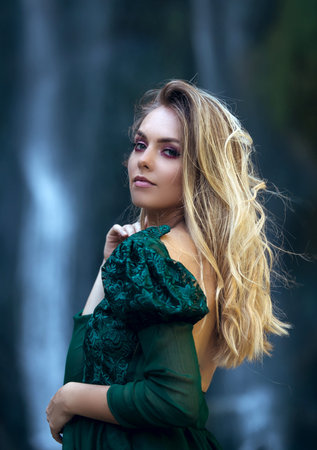 Portrait of a young beauty on the background of the Bliha waterfall in the nature of Bosnia and...