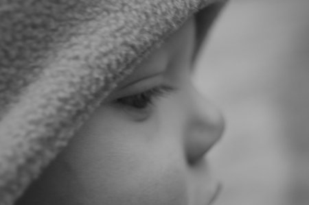 This is a closeup side view black and white photo of a baby, for a unique soft focused picture.