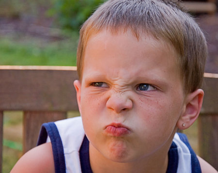 This 5 year old Caucasian boy is angry and his facial expression clearly shows his feelings.