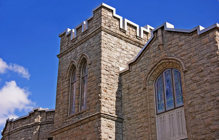 This is an ancient brick stone church that somewhat resembles a castle like appearance against a...