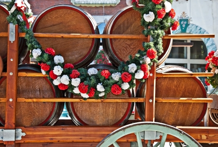 barrels or kegs of beer in a cart, draped with a garland of flowers for a celebrationの写真素材