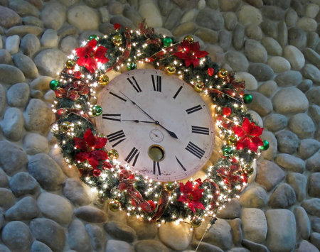 This holiday image is a large clock decorated with Christmas lights, wreath and other decor, hung on...