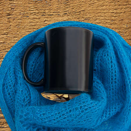 Black cup with lace blue scarf on a peeling paint background with copyspace on the coffee cup.の写真素材