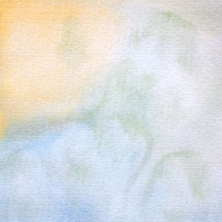Watercolor abstract pattern background in yellow, blue and green tones in this handpainted watercolor paint textures design element.の写真素材