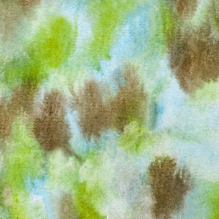 Earthy watercolor pattern background in shades found in nature of brown, green and blue in this handpainted paint texture design element.の写真素材