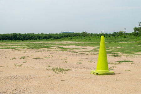 green traffic cone on empty landの写真素材