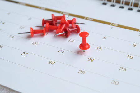 red push pin on calendarの写真素材