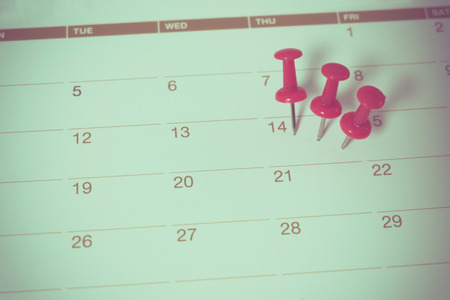 red push pin on calendarの写真素材
