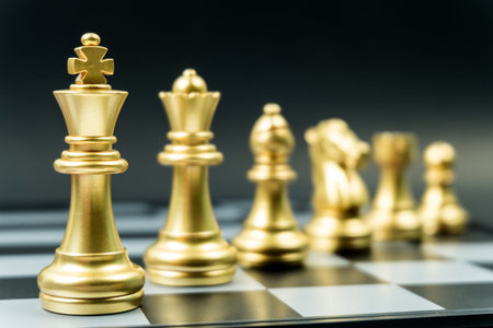 Row of gold chess team on board , black background