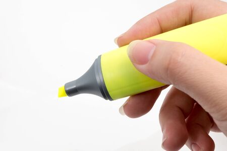 Close Up  Hand with yellow highlighters  isolated on white backgroundの写真素材