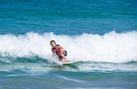 PHUKET, THAILAND - SEPTEMBER 21: A little Western boy practicing sufing in Kata beach -Phuket island, Thailand on September 21,2014. Kata beach is the paradise for surfer on Monsoon season.のeditorial素材