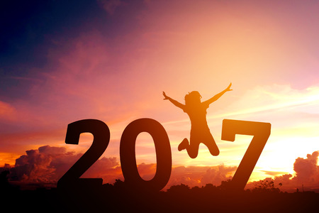 Silhouette young woman jumping to 2017  new yearの写真素材