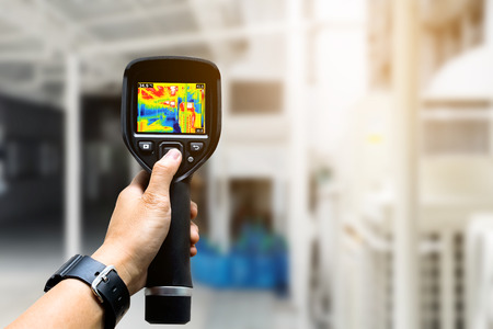 technician use thermal imaging camera to check temperature in factoryの写真素材
