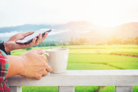 Man using his Mobile Phone outdoor in Morningの写真素材