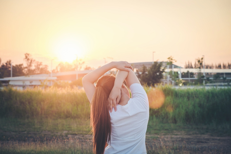 Women exercising in sunny bright light.in parkの写真素材
