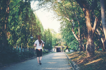 Young lady running and exercise in parkの写真素材