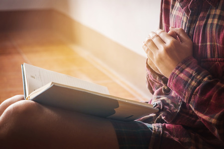 man praying on holy bible in the morningの写真素材