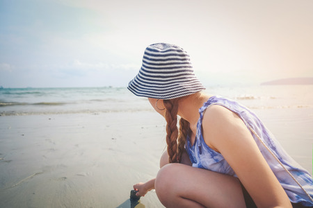 Woman in summer vacation Enjoying Beautiful Sunset on the Beachの写真素材