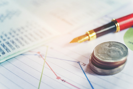 Pen and coin on the business paper. Report chartの写真素材