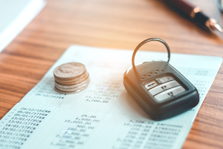 Car insurance,Car remote and account book in finance and banking conceptの写真素材