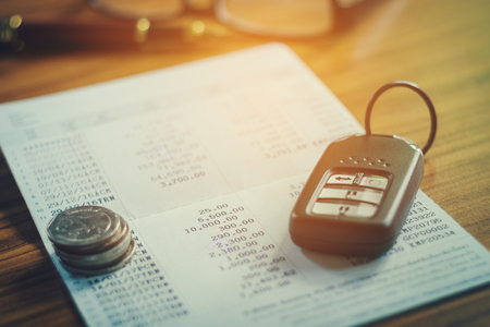 Car insurance,Car remote and account book in finance and banking conceptの写真素材