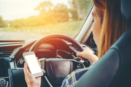Woman traveler Using Smart Phone Car Insideの写真素材