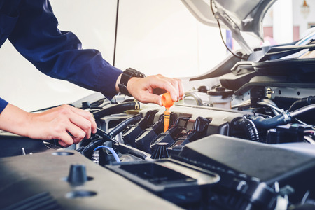 Mechanic changing oil mechanic in auto repair service.の写真素材