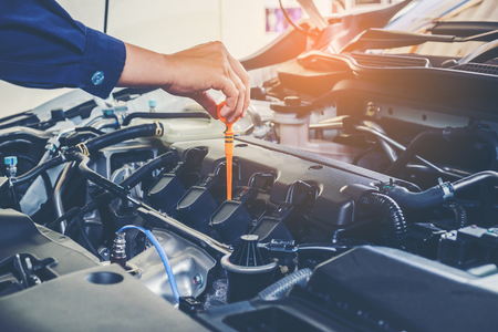 Mechanic changing oil mechanic in auto repair service.の写真素材