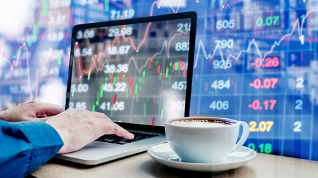 Businessman using laptop trading graph  the stock exchange trading graph screen backgroundの写真素材