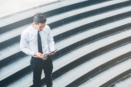 Businessman  Using Digital Tablet at city outside officeの写真素材