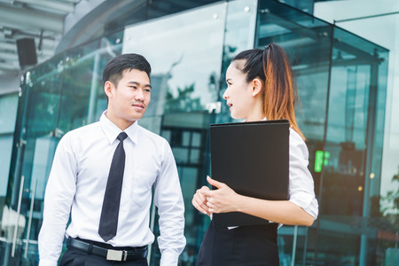Asian Business people talking outside office after workの写真素材