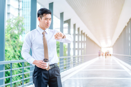 Businessman looking at watch he looks on the timeの写真素材