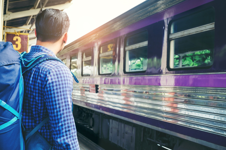 Tourist Man backpacker to travel at train stationの写真素材