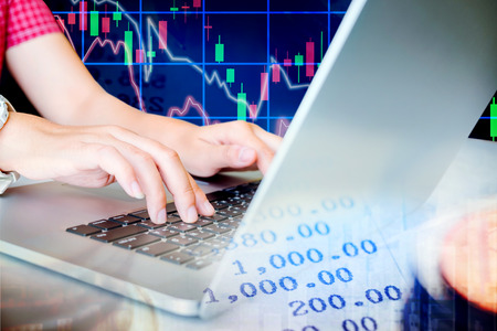 Woman working Laptop Stock market exchange information and Trading graphの写真素材