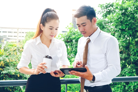 Asian business people using digital tablet outdoor after work  Business outdoor conceptの写真素材