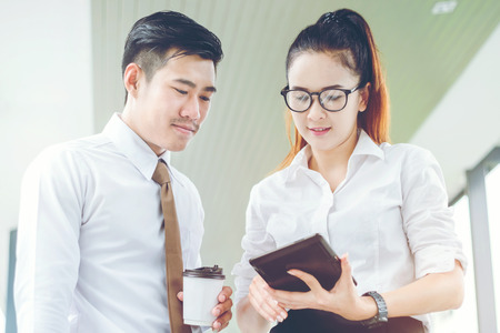Asian business people using digital tablet outdoor after work  Business outdoor conceptの写真素材
