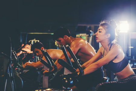 Group of people in the gym exercising legs doing cardio trainingの写真素材