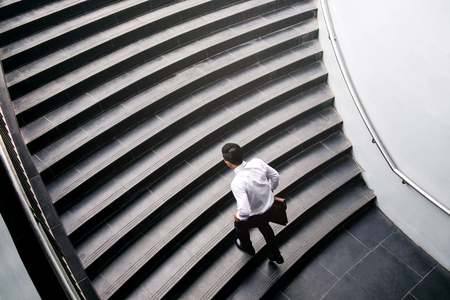 Businessman running fast upstairs Growth up Success conceptの写真素材