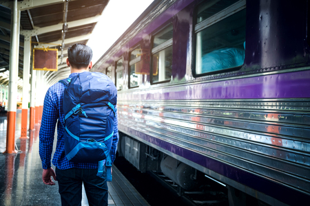 Tourist Man backpacker to travel at train stationの写真素材
