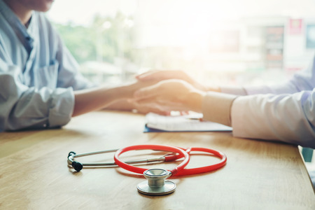 Doctor holding hands for and care patientの写真素材