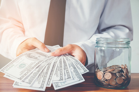 Business man holding dollar billsの写真素材