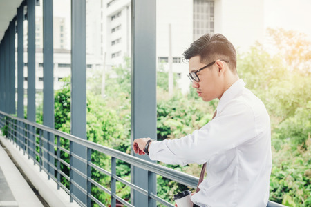 Businessman looking at watch he looks on the timeの写真素材