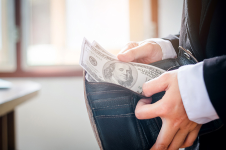 Business man holding dollar bills Payingの写真素材