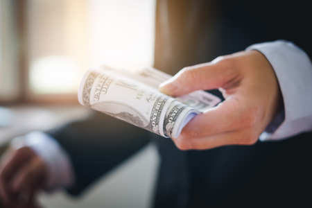 Business man holding dollar billsの写真素材