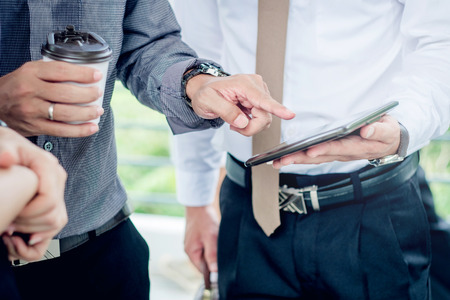 Group of Business people talking withbusinessman working on digital tablet in outdoor after workの写真素材