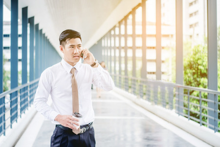 Professional businessman  using smartphone talking on his phone  outsideの写真素材