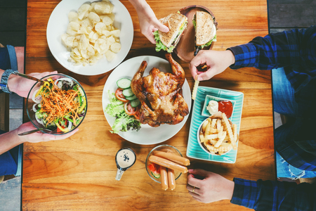 People Party and eating grilled chicken are happy enjoying in homeの写真素材