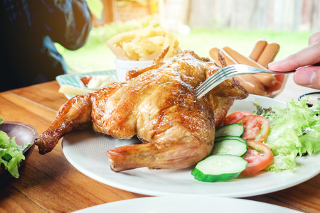 People Party and eating grilled chicken are happy enjoying in homeの写真素材